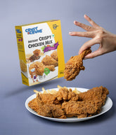 Crust & Crumb crispy chicken mix seasoning on a plate with a hand holding a piece of chicken.
